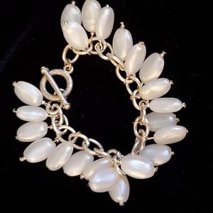 Silvertone toggle closure bracelet with oval pearly bead charms